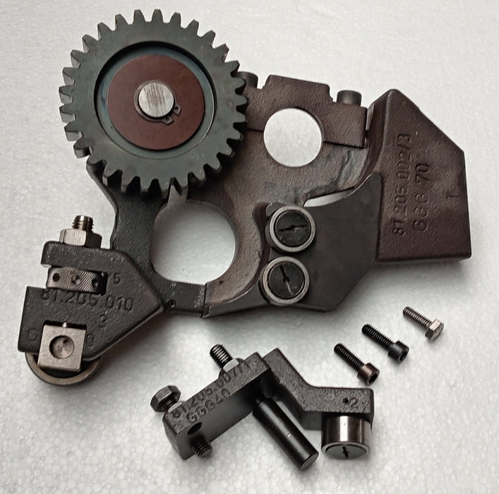Mechanical parts including gears and metal components on a light gray background